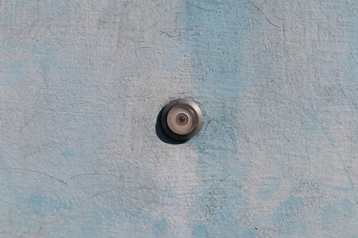 Door peephole on a worn door