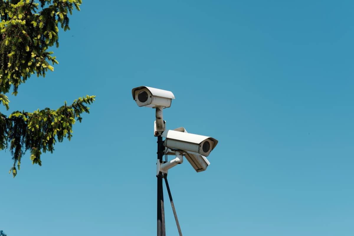 Security cameras on a pole against blue sky